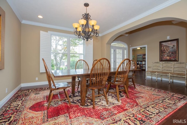 dining area featuring a notable chandelier, wood-type flooring, and crown molding