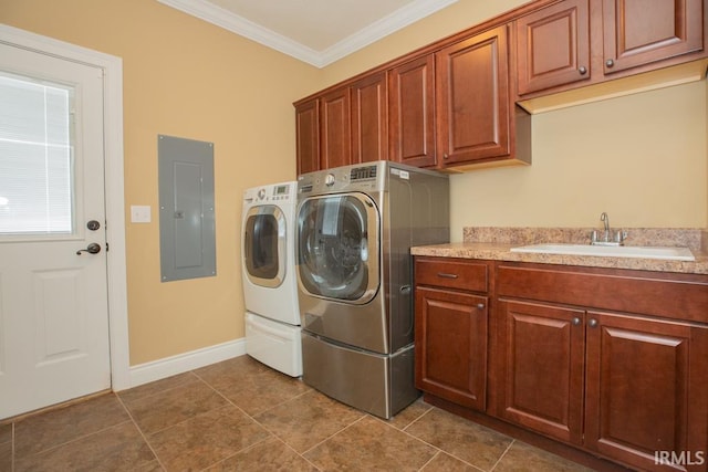 washroom with cabinets, washer and clothes dryer, crown molding, tile flooring, and sink