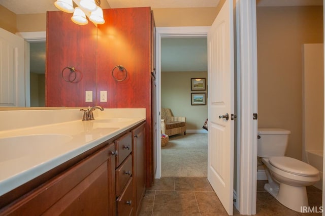 bathroom with double sink vanity, tile flooring, and toilet