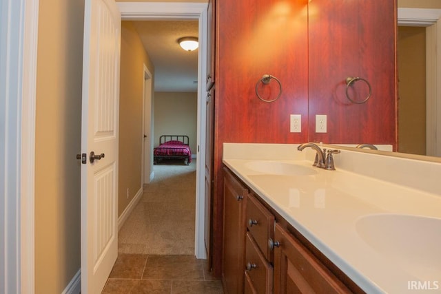 bathroom featuring tile flooring, dual sinks, and large vanity