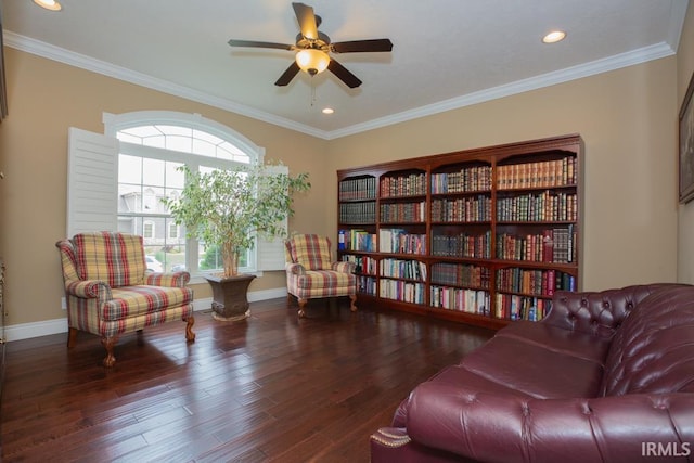 living area with dark hardwood / wood-style flooring, ornamental molding, and ceiling fan