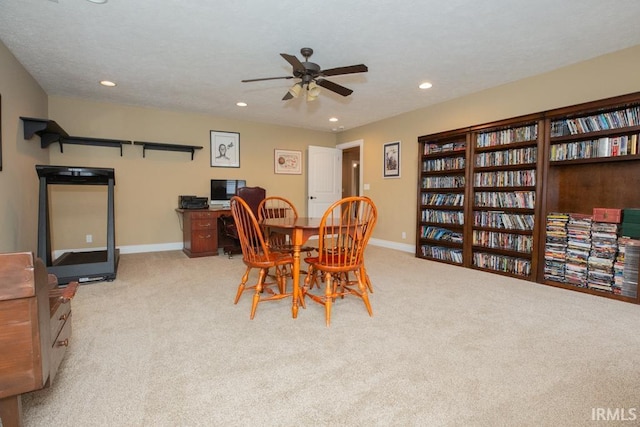 dining space with ceiling fan and carpet floors