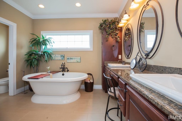 bathroom featuring a washtub, double sink vanity, tile floors, and crown molding