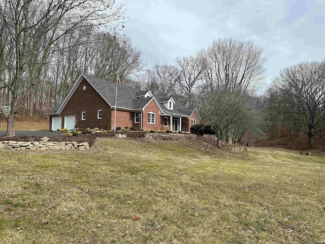 view of front of home with a front lawn and a garage