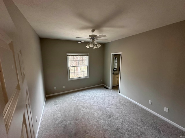 carpeted empty room featuring ceiling fan