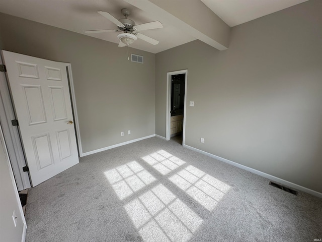 empty room with beamed ceiling, carpet, and ceiling fan