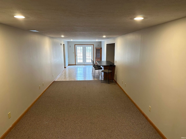 corridor with carpet flooring and french doors