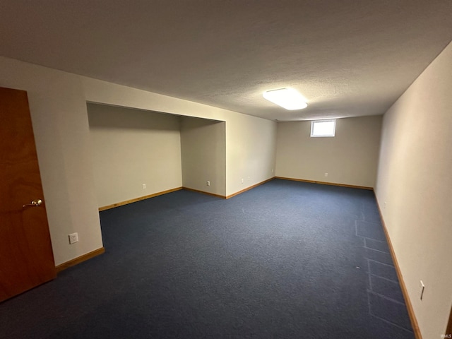 carpeted empty room featuring a textured ceiling