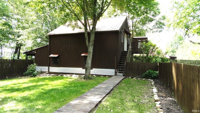 view of side of property with a yard