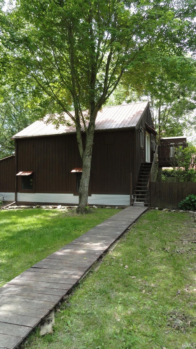 view of side of home featuring a lawn