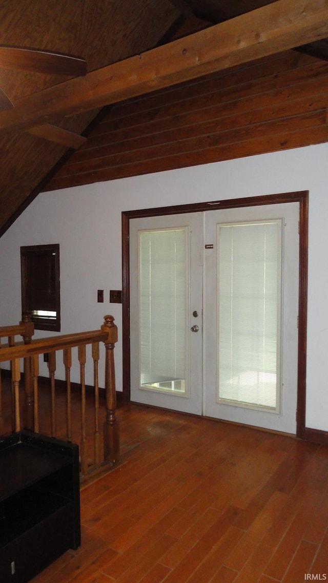 foyer with hardwood / wood-style floors and vaulted ceiling with beams