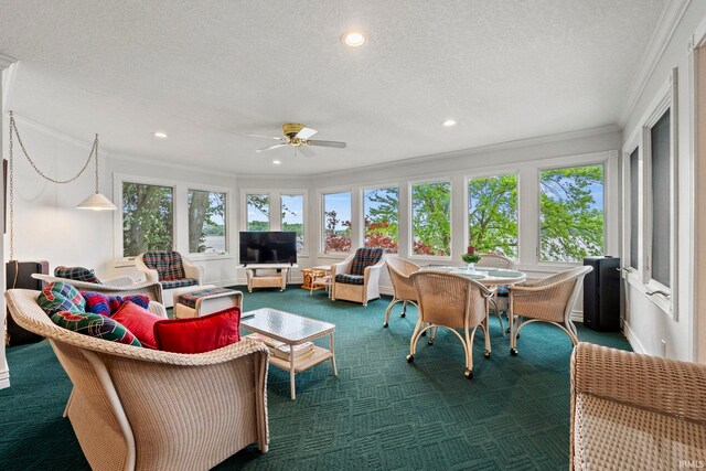 carpeted living room with a healthy amount of sunlight, a textured ceiling, and crown molding