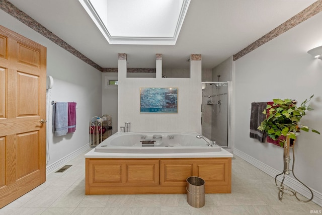 bathroom with tile floors, separate shower and tub, and a skylight