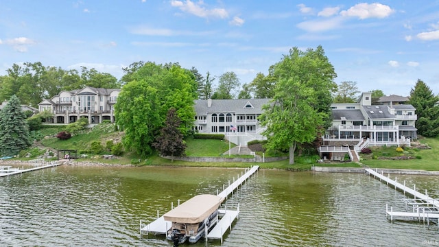 dock area with a water view and a balcony