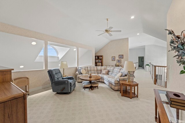 carpeted living room featuring ceiling fan and lofted ceiling with skylight