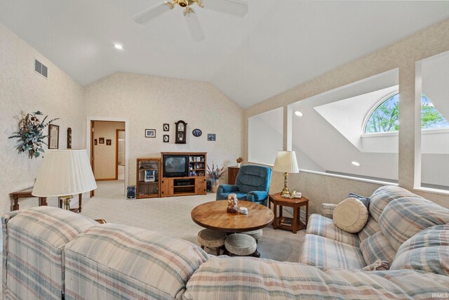 living room featuring ceiling fan, vaulted ceiling, and carpet flooring