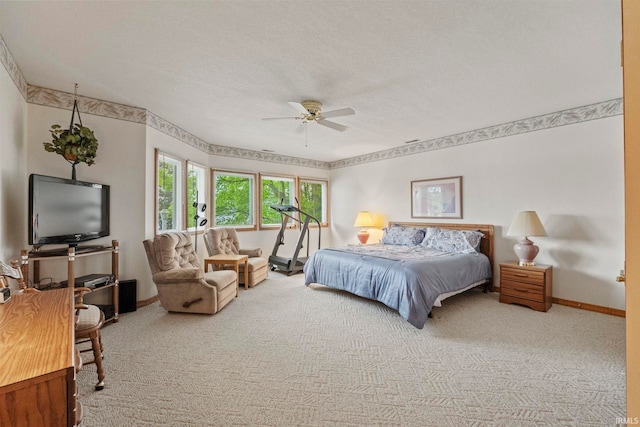 bedroom with a textured ceiling, carpet floors, and ceiling fan