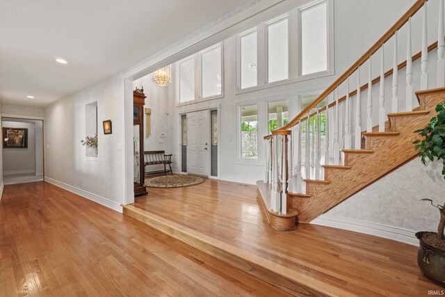 entrance foyer with a high ceiling and hardwood / wood-style flooring