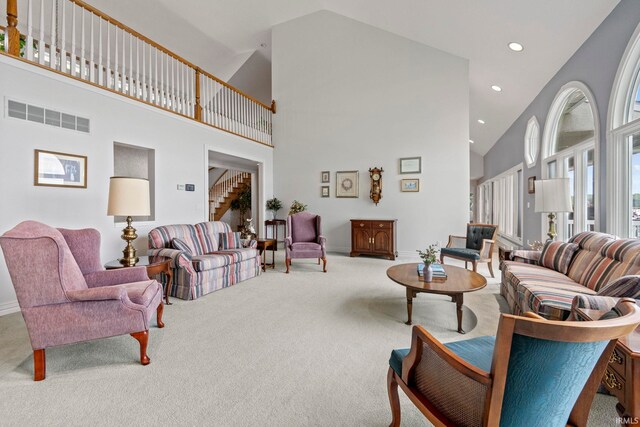 living room featuring high vaulted ceiling and carpet floors