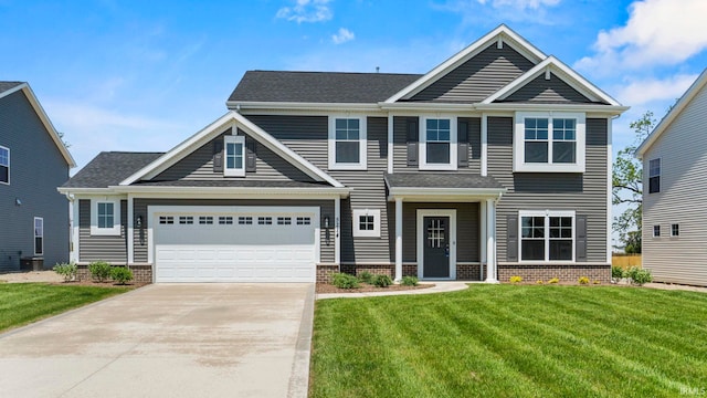 craftsman house featuring a garage and a front yard