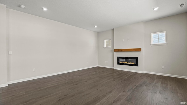 unfurnished living room featuring dark hardwood / wood-style flooring