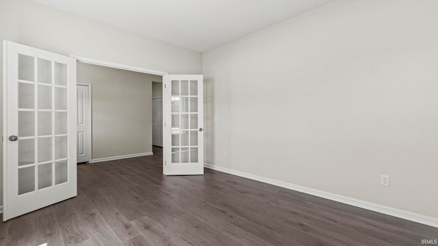 spare room with dark hardwood / wood-style flooring and french doors