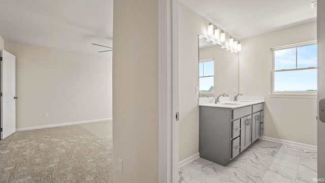 bathroom featuring tile floors, ceiling fan, and vanity