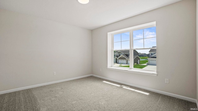 carpeted empty room with plenty of natural light