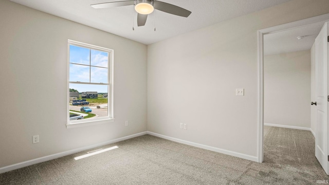 unfurnished room with ceiling fan and carpet floors