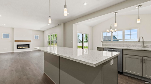 kitchen with dark hardwood / wood-style floors, dishwasher, pendant lighting, a center island, and sink