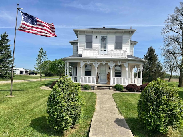 italianate-style house with covered porch and a front lawn