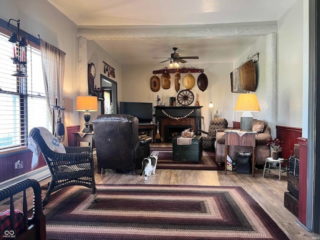 living room featuring wood-type flooring and ceiling fan