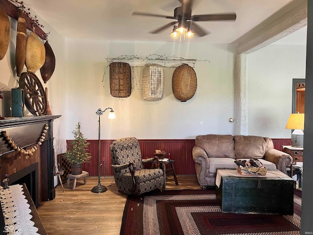 living room featuring ceiling fan and hardwood / wood-style flooring