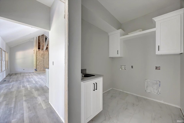 clothes washing area with light hardwood / wood-style flooring