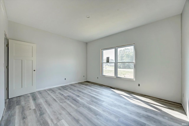 spare room with light wood finished floors and visible vents