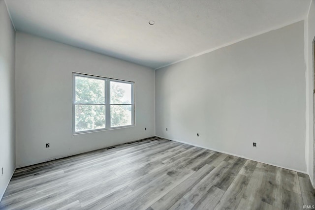 spare room featuring light wood-type flooring