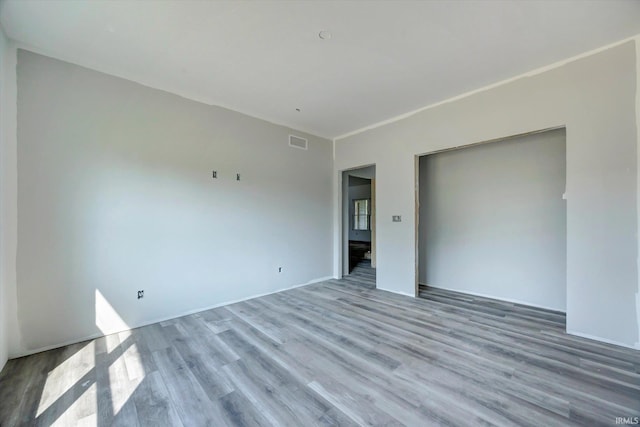 spare room featuring wood-type flooring