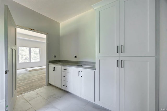 bathroom featuring marble finish floor and vanity