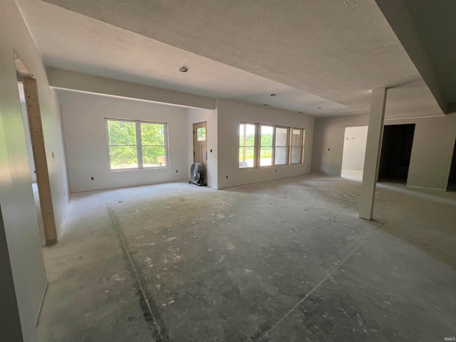 interior space with a textured ceiling and a wealth of natural light