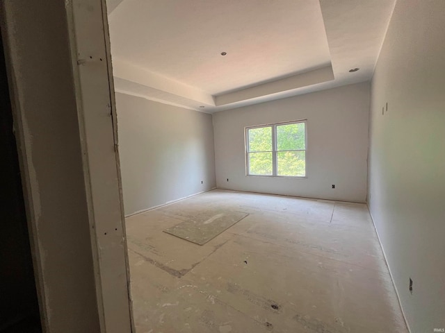 empty room featuring a raised ceiling