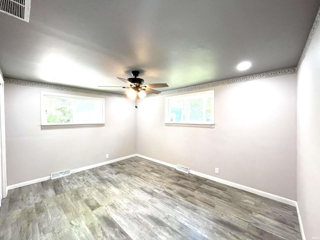 empty room with ceiling fan and wood-type flooring