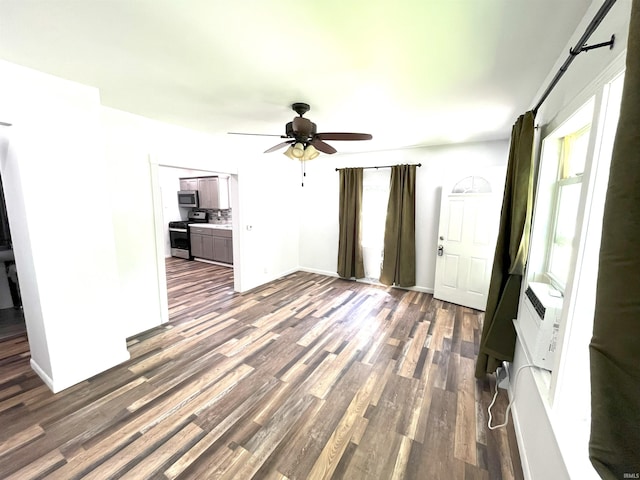 interior space with dark wood-type flooring and ceiling fan