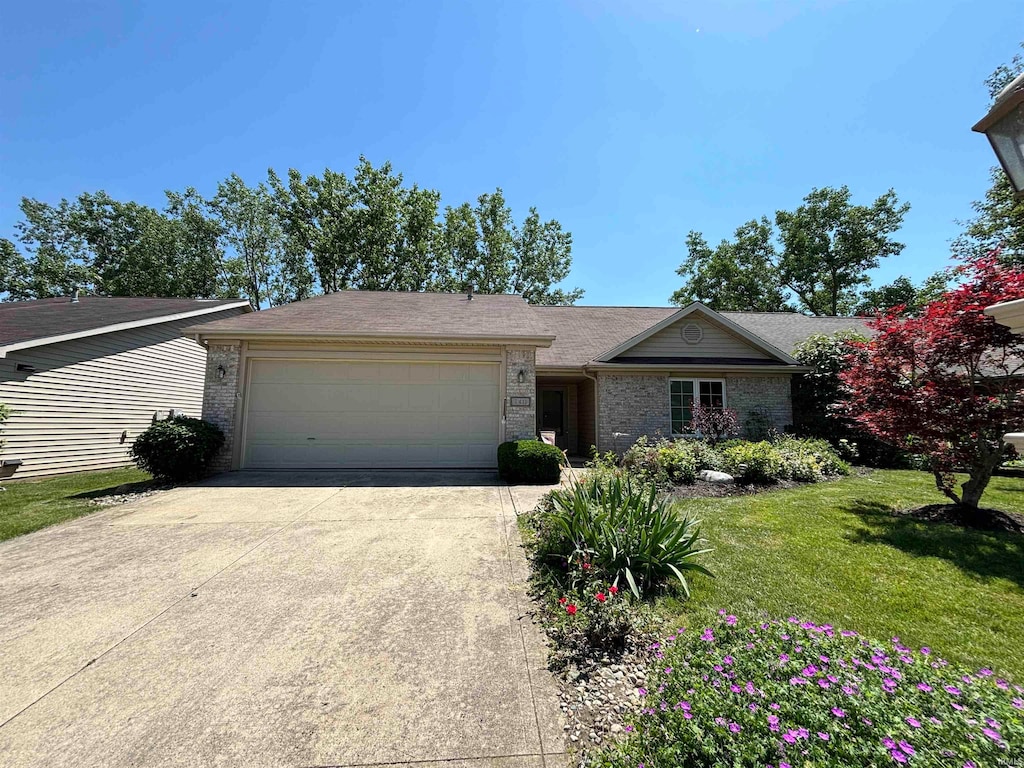 single story home with a garage and a front yard