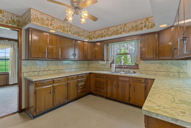 kitchen with ceiling fan, sink, and a wealth of natural light