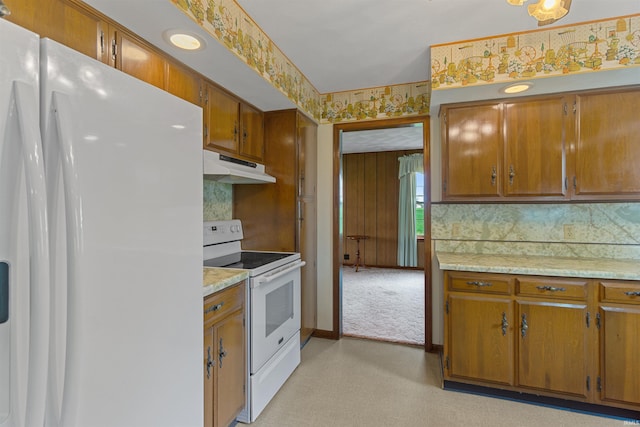 kitchen featuring tasteful backsplash and white appliances