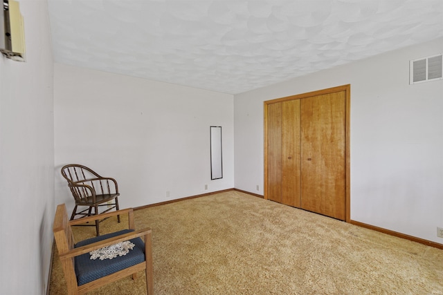 unfurnished room with carpet flooring and a textured ceiling