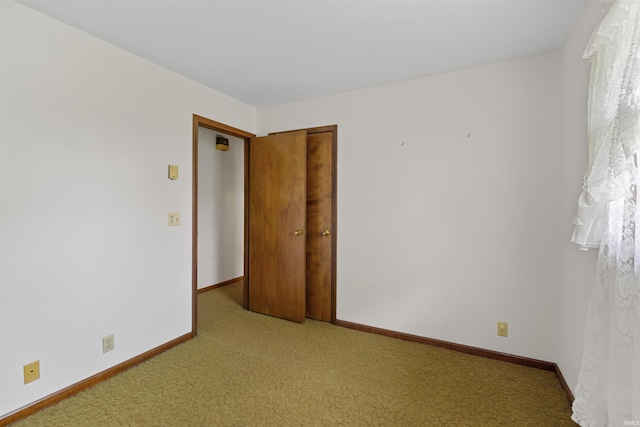 spare room featuring light carpet