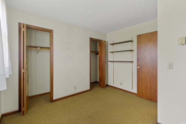 unfurnished bedroom featuring light carpet and a closet