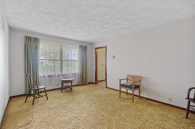 sitting room featuring light colored carpet