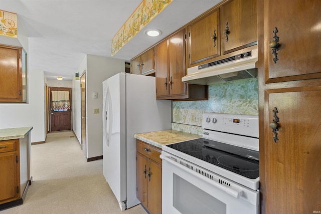 kitchen featuring decorative backsplash and white appliances